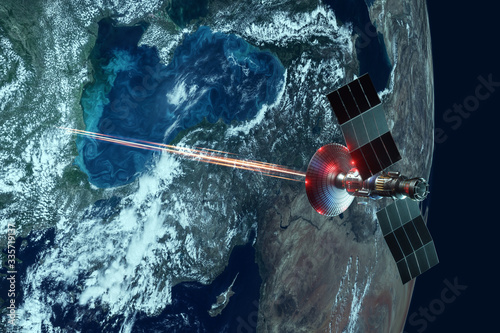 Fototapeta Naklejka Na Ścianę i Meble -  Space military satellite, a weapon in space shoots a laser against the background of the earth. Attack, technology, space war. mixed medium, copy space. image furnished by NASA.