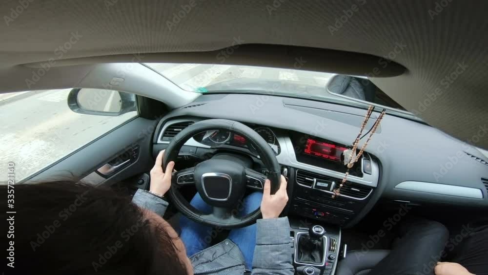 Female driving a luxury car, view from inside out Female driving a luxury car, view from inside out