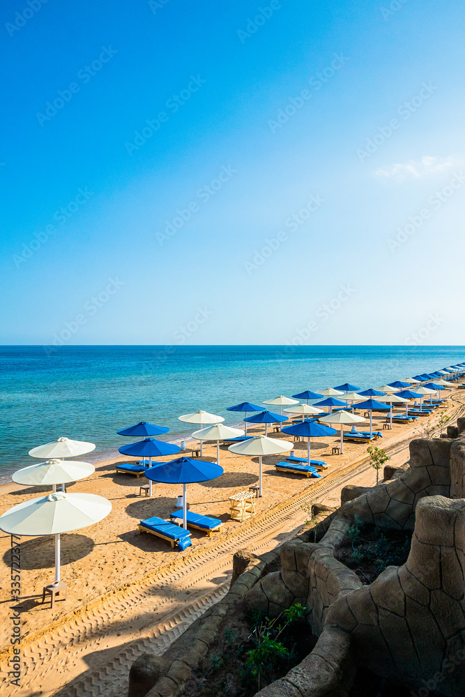 beach umbrellas on the seashore. rest in egypt. The first coastline of the hotel.