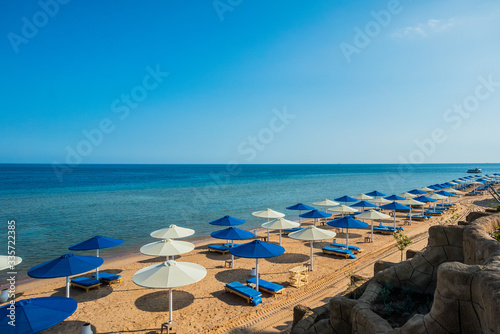 beach umbrellas on the seashore. rest in egypt. The first coastline of the hotel. © Artem Orlyanskiy