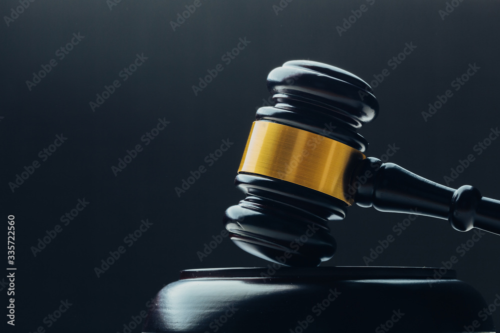 Judge's gavel with gold metal on a black table. Concept of law Judge's gavel with gold metal on a black table. Concept of law