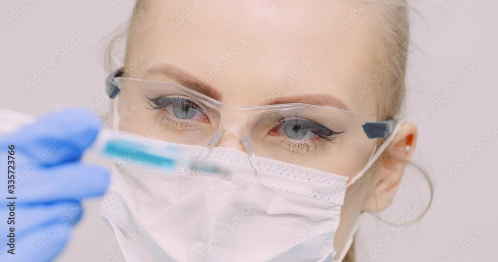 Extreme Close up of Hand Holding Syringe and Vaccine in Hand in Laboratory. Extreme Close up of Hand Holding Syringe and Vaccine in Hand in Laboratory.