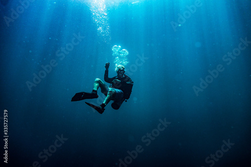 Scuba diver during safety stop in deep blue sea
