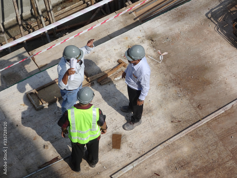 Construction workers having a discussion at the construction site. Important discussions to coordinate construction work. Construction workers having a discussion at the construction site. Important discussions to coordinate construction work.