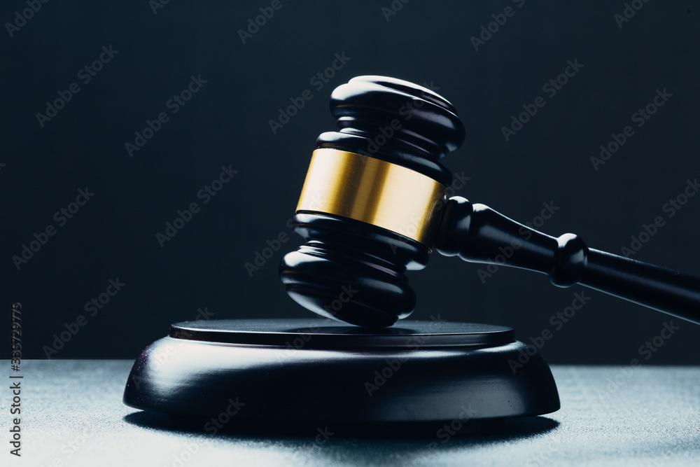 Judge's gavel with gold metal on a black table. Concept of law Judge's gavel with gold metal on a black table. Concept of law