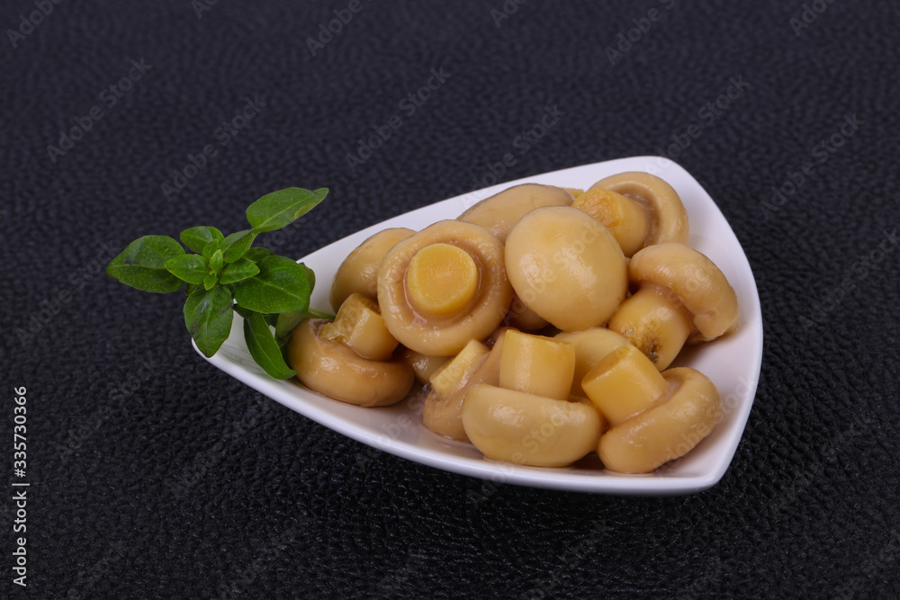 Pickled champignon heap in the bowl Pickled champignon heap in the bowl