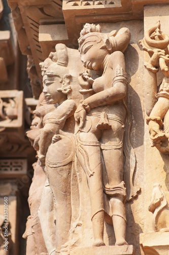 Stone carved erotic bas-relief Sculpture of love making in Kandariya Mahadeva Temple, Group of Monuments, India photo