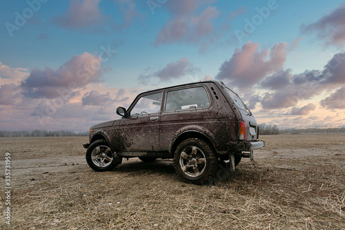 dirty SUV on the field at sunset © gluschenkoart