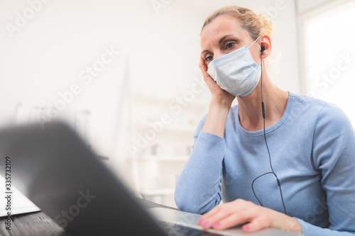 Online teacher with a protective mask tutoring over the internet.