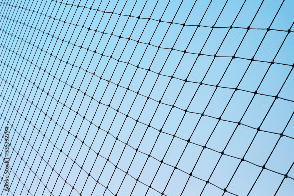 Football protection net on bright blue sky background Football protection net on bright blue sky background