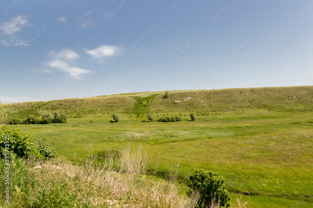 Soft landsсape with yellow meadows and forests far away. Light blue sky. Fall fields 