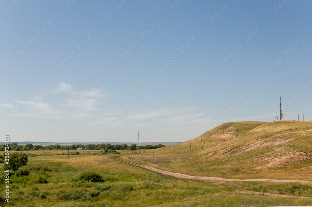 Soft landsсape with yellow meadows and forests far away. Light blue sky. Fall fields Soft landsсape with yellow meadows and forests far away. Light blue sky. Fall fields