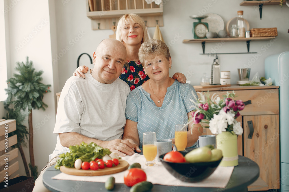 Family in a kitchen. Grandparents with grandchildren. People with vegetables Family in a kitchen. Grandparents with grandchildren. People with vegetables