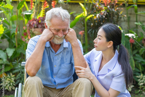 Young nurse take care senior man at home, Senior man happniess and smiling with nurse, Health care concept photo