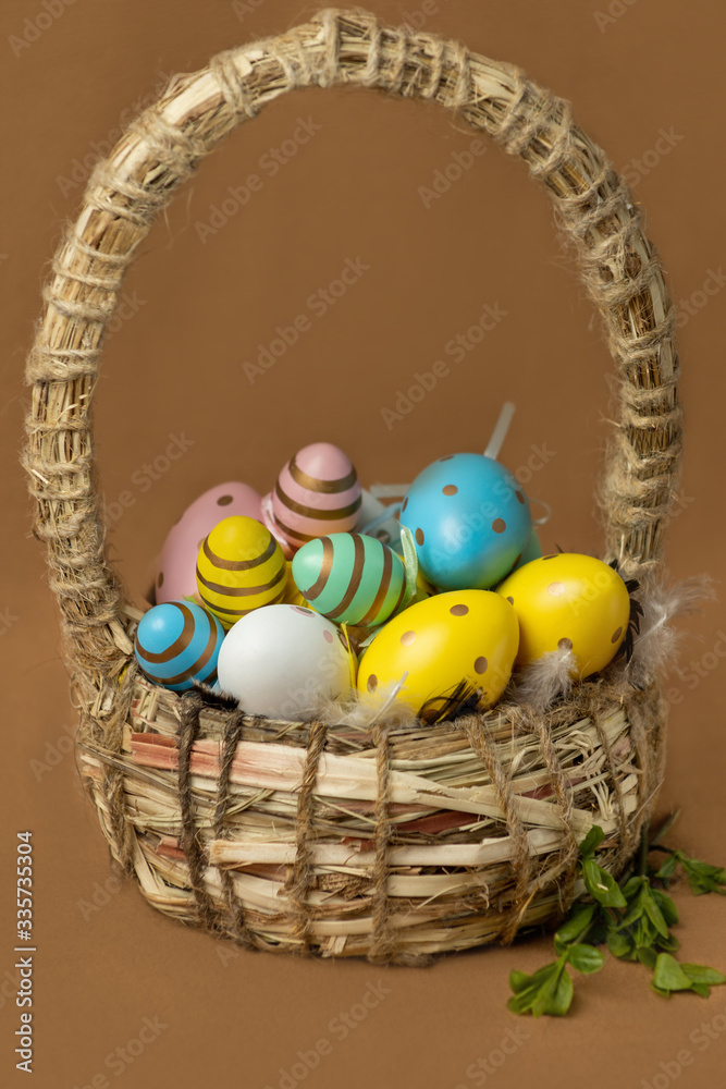 Wicker basket with red Easter eggs on a brown background Wicker basket with red Easter eggs on a brown background