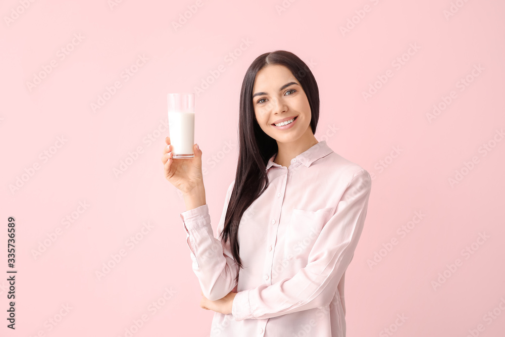 Beautiful young woman with milk on color background Beautiful young woman with milk on color background
