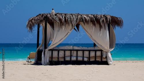 Marsa Matruh, Egypt. Elegant gazebo on the beach. Amazing sea with tropical blue, turquoise and green colors. Relaxing context. Nobody on the beach. Fabulous holidays. Mediterranean Sea. North Africa