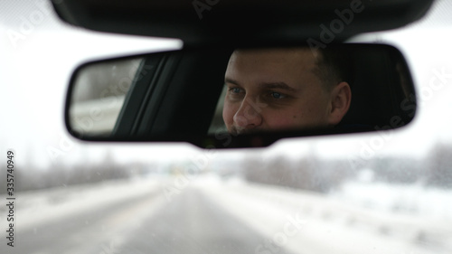 Young handsome man driving a car in winter © emaria
