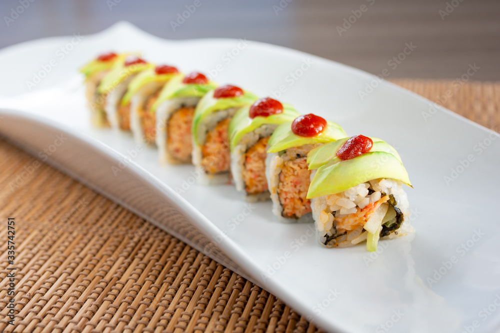 A view of a Mexican roll sushi plate, in a restaurant or kitchen setting.