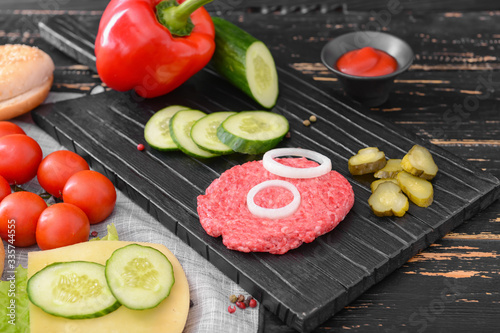 Ingredients for tasty burger on wooden table