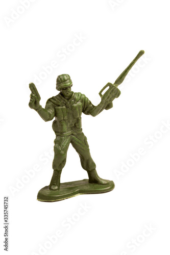Simple dark green plastic toy soldier holding a pistol and a machine gun in hands  holding them up in a victory gesture Infantry figure object isolated on white  cut out Winning warfare concept symbol
