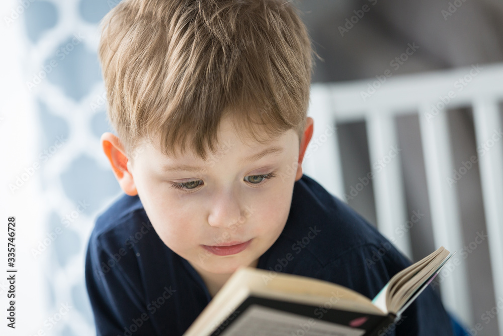 Little boy reading a book at home Little boy reading a book at home