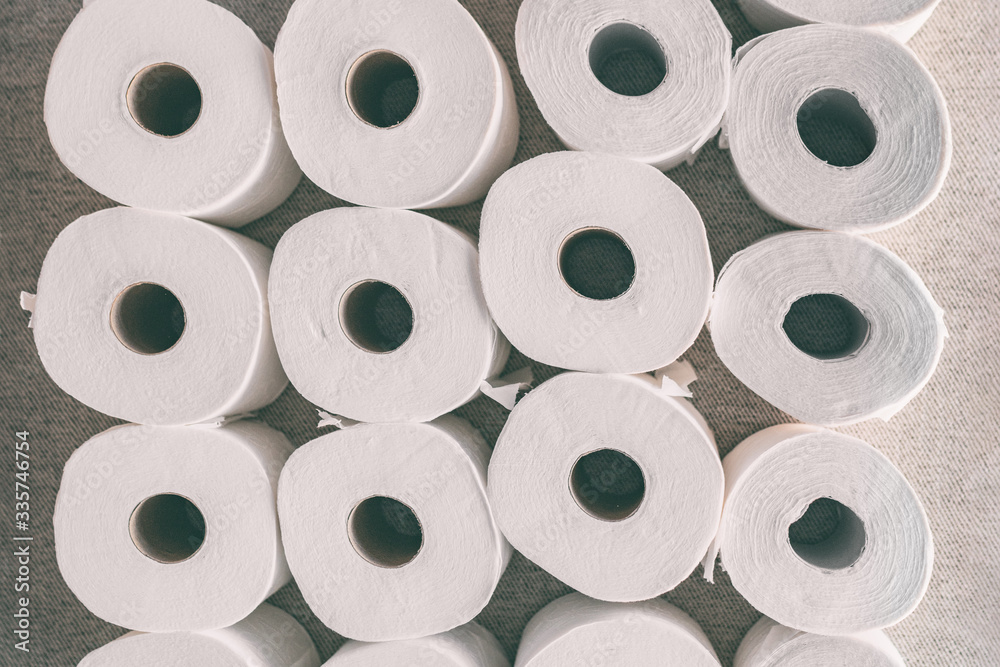 Toilet paper rolls background top flat view of many open rolls. Hoarding of bathroom tissues in fear of store supply shortage during coronavirus COVID-19 panic buying. Toilet paper rolls background top flat view of many open rolls. Hoarding of bathroom tissues in fear of store supply shortage during coronavirus COVID-19 panic buying.