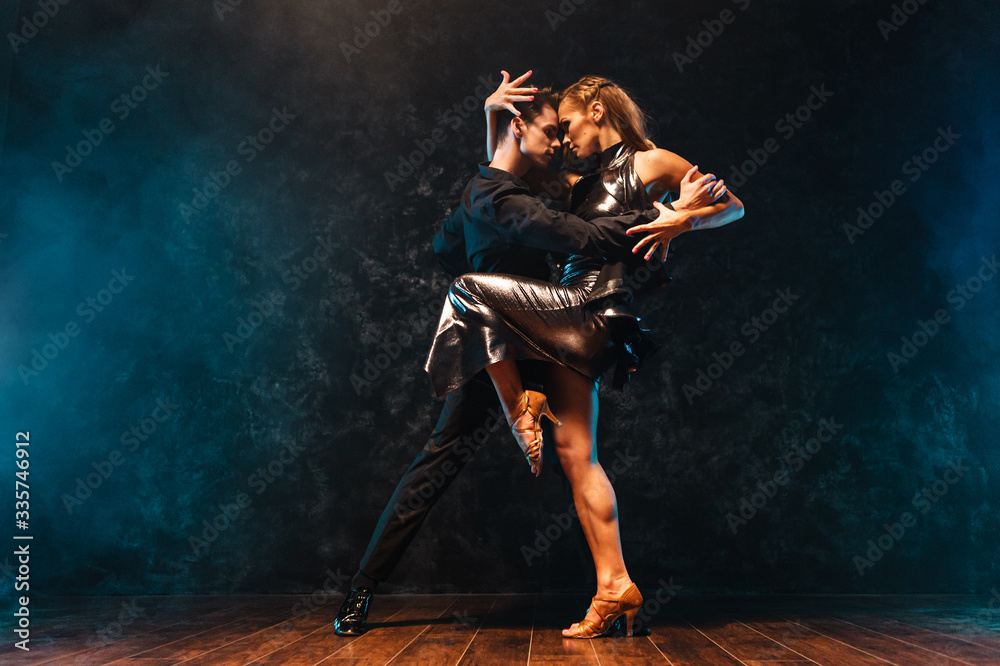 young couple in elegant evening dresses dancing - obrazy, fototapety, plakaty 