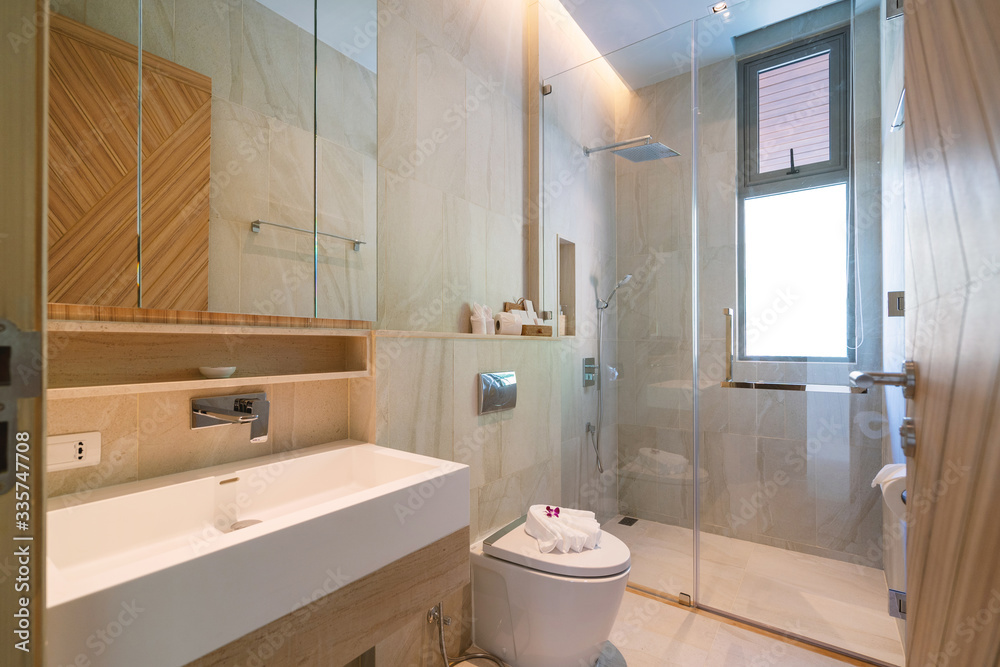 Interior design in bathroom of villa, house, home, condo and apartment feature basin, shower, mirror and towels Interior design in bathroom of villa, house, home, condo and apartment feature basin, shower, mirror and towels
