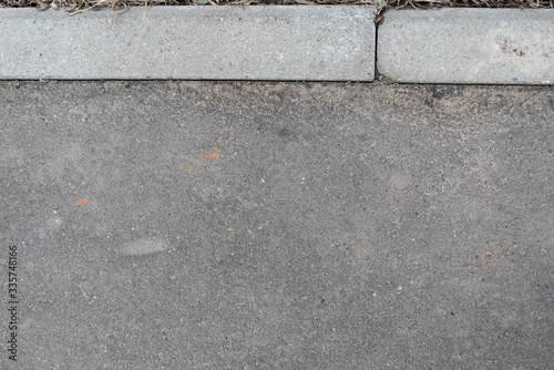 Grey texture of asphalt surface and paving bar. Background of asfalt and stones