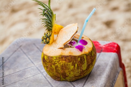 Closeup on tropical beach coconut cocktail bar preparement.