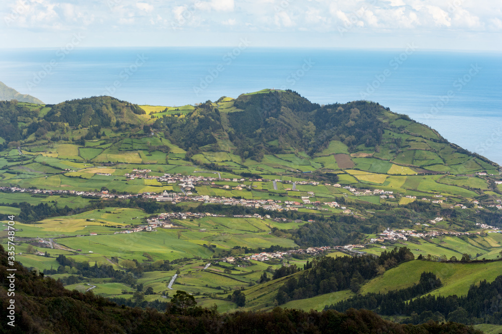 Obraz premium View on town of Furnas, located in the same name a civil parish in the municipality of Povoacao on the island of Sao Miguel in the Portuguese Azores, as seen from the Pico do Gaspar Belvedere.