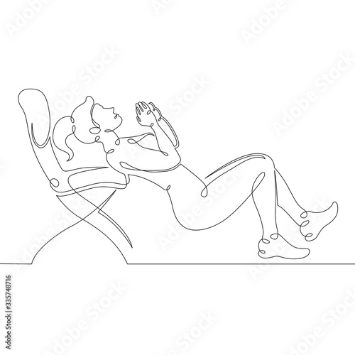 The girl is engaged in fitness yoga at home on a chair. Quarantine coronavirus pandemic. Sport stay home