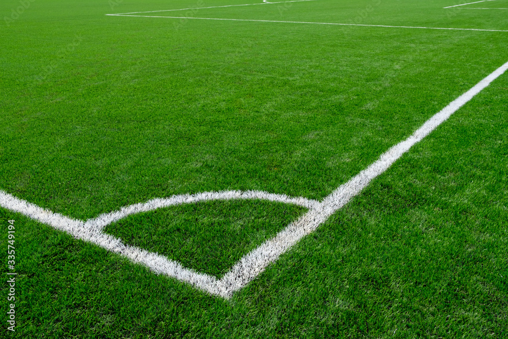 white corner markings on a football field with artificial turf