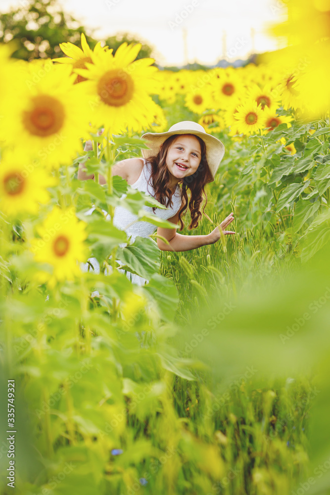 Cute girl(child) playing in the sunflowers field with sunflowers. Stock ...