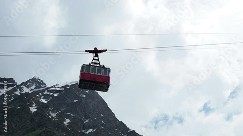Red cable car in the background of the mountains Old red cable car at mountain with tourists