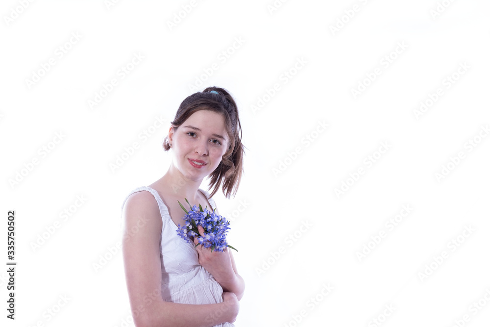 young girl holds a bouquet of spring flowers against young girl holds a bouquet of spring flowers against