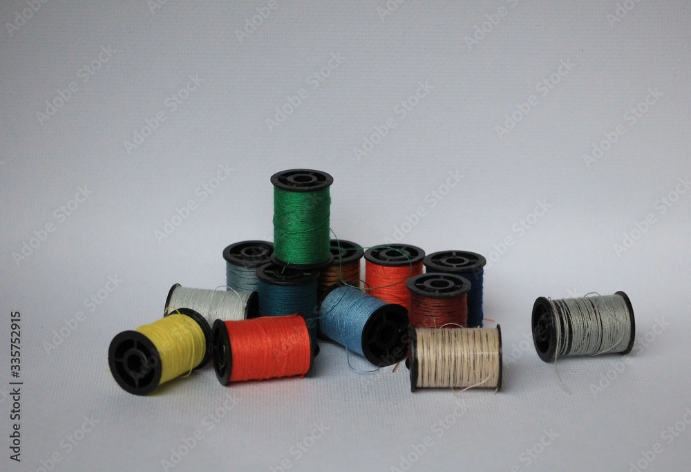 multicolored of thread spools on white background multicolored of thread spools on white background