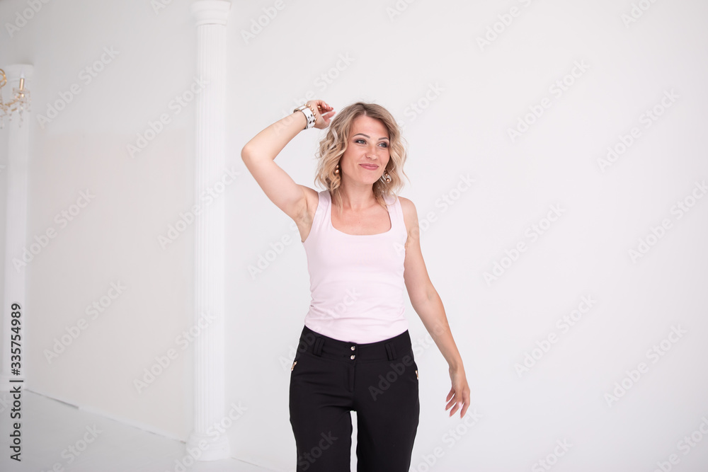 Portrait of young business woman white shirt black trousers pants isolated, dances Portrait of young business woman white shirt black trousers pants isolated, dances