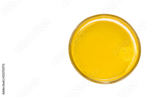 Overhead view of glass of prepared orange flavored vitamin c effervescent