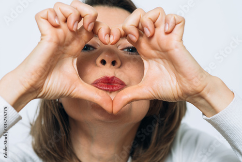 woman making a hand heart frame