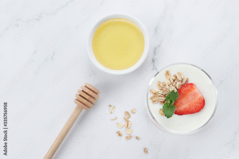 a cup of yogurt and strawberries on the table
a cup of yogurt and strawberries on the table