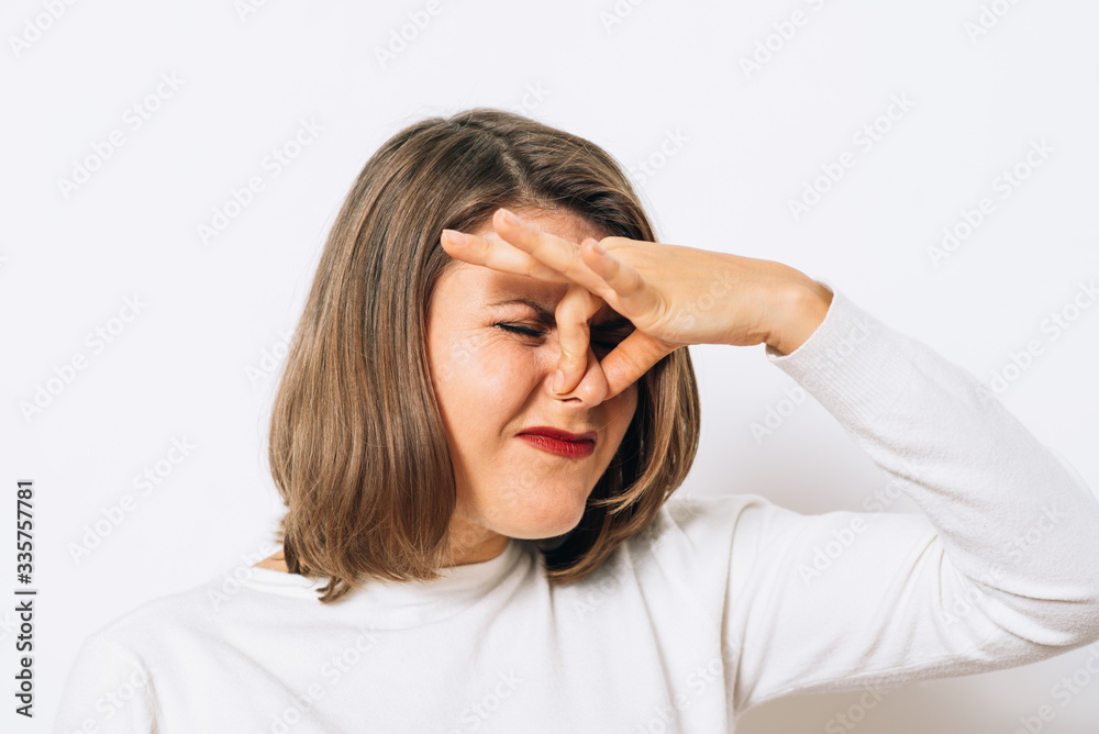 The stench. Closes the woman's nose The stench. Closes the woman's nose