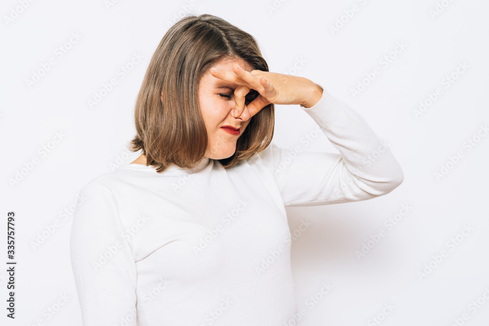 The stench. Closes the woman's nose