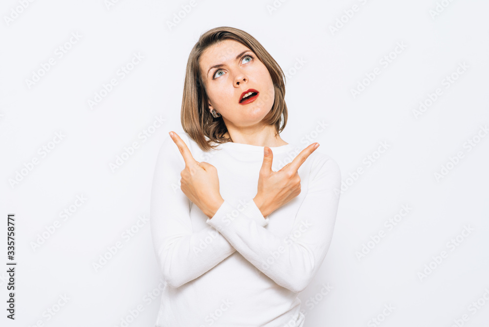 Young woman has to decide between two directions. Girl full of doubts and hesitation Young woman has to decide between two directions. Girl full of doubts and hesitation