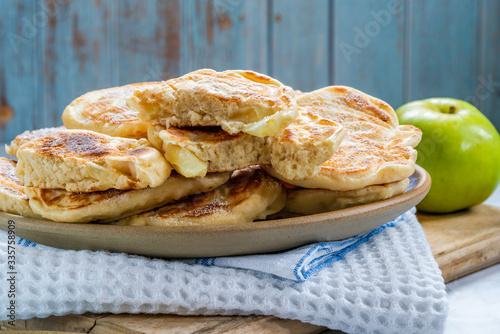 Fluffy homemade pancakes with apple dusted with icing sugar photo