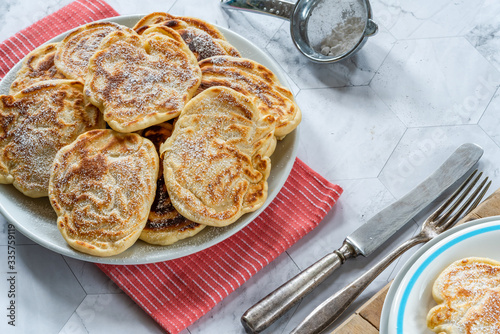 Fluffy homemade pancakes with apple dusted with icing sugar photo