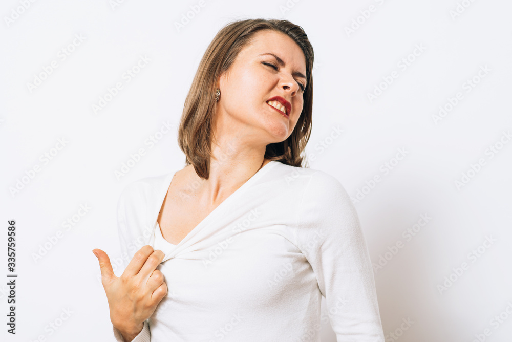 Close-up portrait of a young woman opening shirt to express that hot. Negative emotions, expressing, feeling Close-up portrait of a young woman opening shirt to express that hot. Negative emotions, expressing, feeling