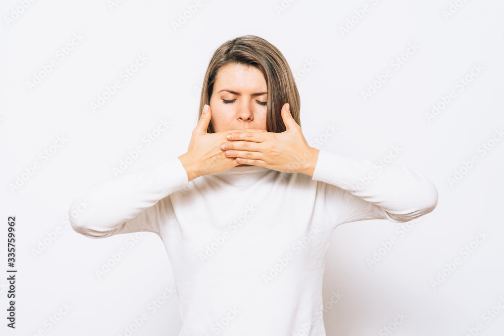 Successful stylish girl covers her mouth with her hands, isolated in the studio Successful stylish girl covers her mouth with her hands, isolated in the studio