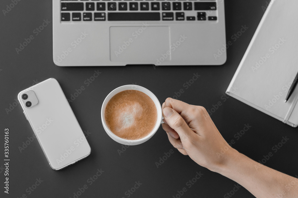Businessman holding a cup in hand. Coffee break office. Flat lay, top view Businessman holding a cup in hand. Coffee break office. Flat lay, top view
